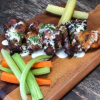 Grilled Chicken Wings · Spicy dry rub, Alabama white BBQ sauce, Pickles, celery and carrot sticks.