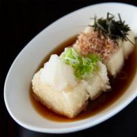 Agedashi Tofu · Crispy fried tofu. Served in a hot tentsuyu broth. Topped with green onions, daikon, and kiz...