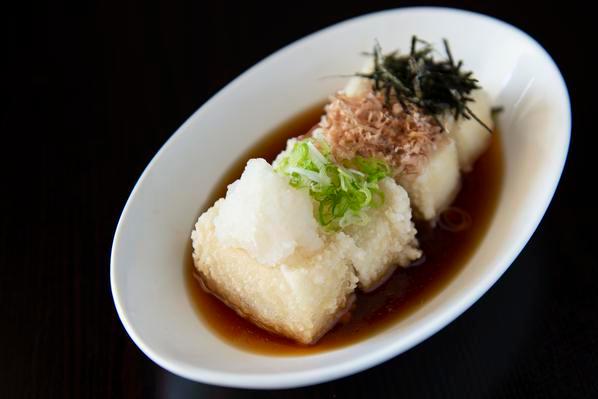 Agedashi Tofu · Crispy fried tofu. Served in a hot tentsuyu broth. Topped with green onions, daikon, and kizame nori.
