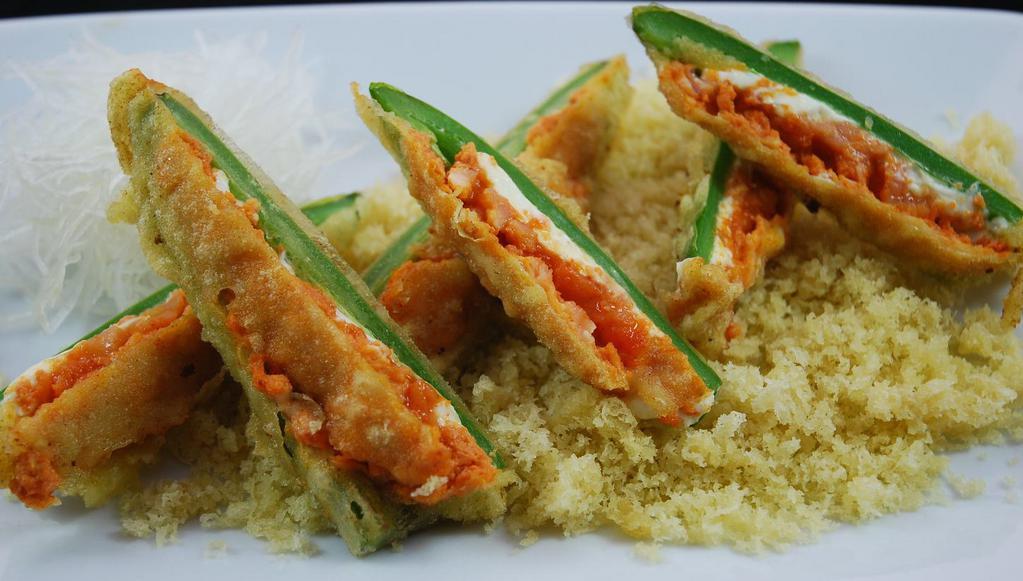 Jalapeno Poppers · Fried jalapenos stuffed with cream cheese and spicy salmon. Topped with spicy mayo and sweet sauce.