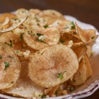 Truffle Chips · House-made potato chips tossed with Parmesan cheese, parsley and truffle oil.