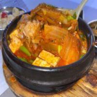 Kimchi Jjigae · Traditional Korean Kimchi stew with assorted vegetables, scallions, soft tofu, and sliced po...