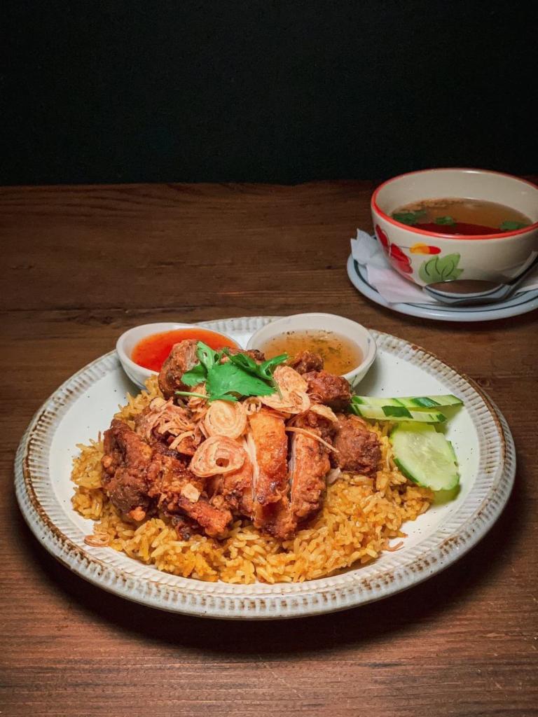 Crispy Chicken Over Rice · Thai style fried chicken topped with crispy shallot served with yellow rice and sweet chili sauce