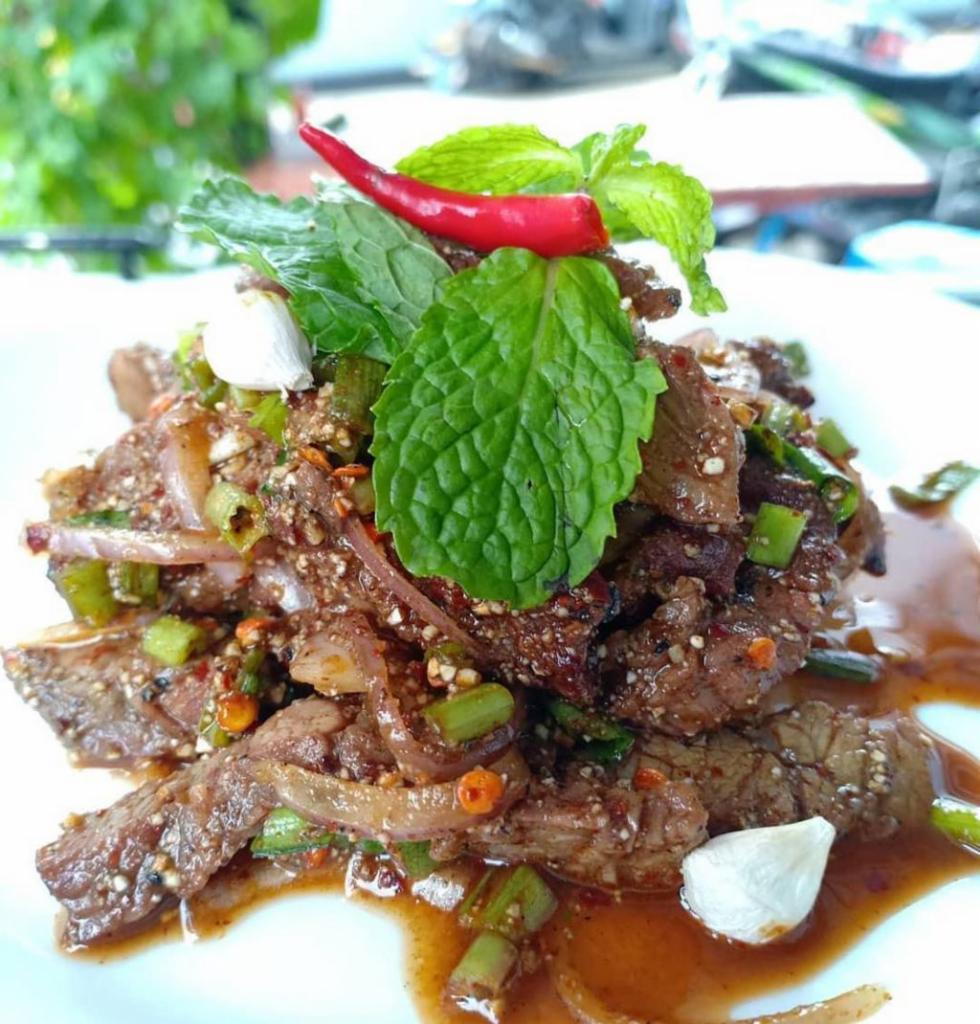 Beef Salad (Gluten-free) · Beef salad north eastern Thai-style. Grilled marinated beef, mint, shallot, toasted rice, recau, dried chili and  lime juice. Medium spicy.