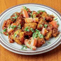 Gobi Manchurian · Cauliflower in sweet & sour sauce with onions and tomatoes. Served with Basmati rice.