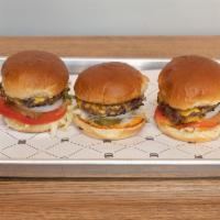 Trio Burger · 3 burgers. Includes Roma tomato, leaf lettuce, shaved onions, pickles, American cheese and h...