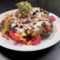 Nachos de la Casa · Served with beans, cheese sauce, ground beef, tomatoes, jalapenos, sour cream and guacamole.
