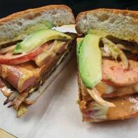 Cubana Torta · Breaded steak, chorizo, egg, ham and melted cheese. Served with beans, onion, tomatoes, chip...