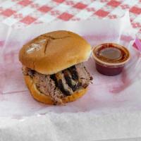 Brisket Sandwich  · 1/3 lb. of sliced brisket topped with dill pickles and BBQ sauce on the side. Add extra sauc...