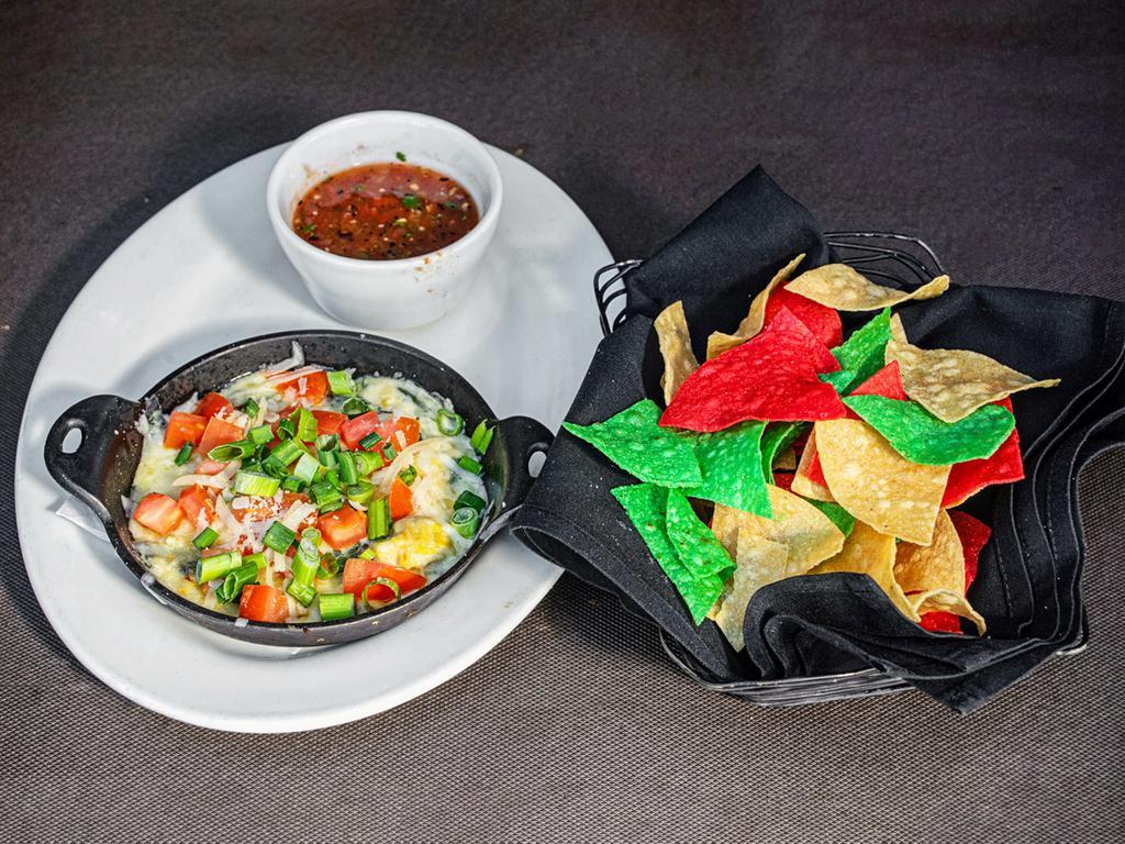 Spinach & Artichoke Dip · A rich and creamy 4-cheese blend with fresh spinach and artichoke hearts. Served with wood-roasted salsa and crisp tortilla chips.