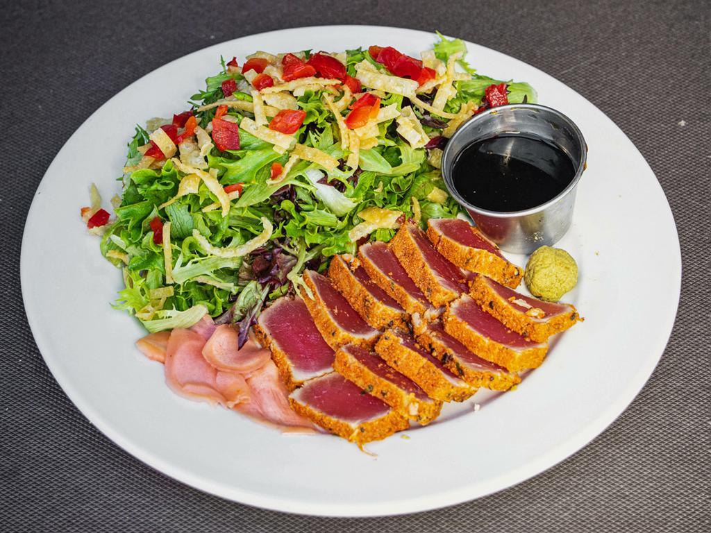 Seared Ahi Tuna · Sashimi-grade tuna, rubbed with Joe's bold spices and seared rare, served with baby greens tossed in a cucumber vinaigrette with a sweet soy dipping sauce.