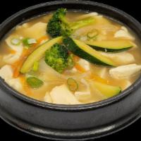 Veggie Tofu Stew · Korean silken tofu in a savory and spicy stew combines with vegetables. Served with rice, fl...