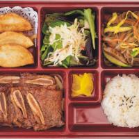Beef Short Ribs Bento Box · Grilled and marinated beef short ribs. Served with rice, fresh seasonal salad, and stir-frie...
