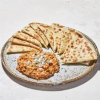 Spicy Feta · crumbled feta cheese, tomato, and spices served with your choice of pita bread or sliced veg...