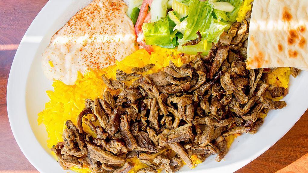 Beef Plate · Authentic lamb recipe on a bed of saffron rice, sides of tzatziki, green salad, and choice of sauces.