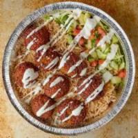 Falafel over rice plate  · Falafel over rice comes with hummus, salad and taziki