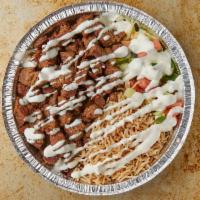 Lamb over rice  · Lamb with grilled onions and peppers topped with white sauce Served with lettuce , tomatoes .