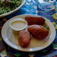 Kibbeh · A ball of ground lamb and burgul wheat stuffed with lamb, onions and almonds and deep fried.
