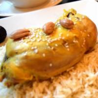 Chicken Tajine · Stewed chicken with apricot, prunes, figs, honey, sesame and almonds, served with rice.