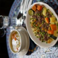 Lamb Couscous · Lamb stew with potatoes, carrots, zucchini, turnips, sweet potatoes and sweet green peas. Se...