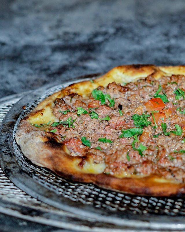 Safiha Pizza · Traditional pizza with ground lamb, beef, tomato, parsley, onion, and spices.