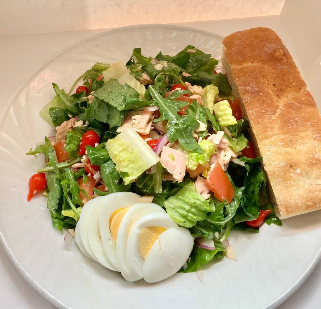 Tuna Salad Platter · Arugula and romaine, imported tuna, tomatoes, onions, olives, peppers, and hard-boiled egg.