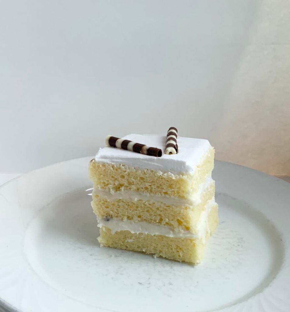 Cannoli Cake Slice · Vanilla cake with cannoli cream.