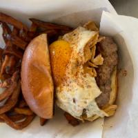Sunny Side Up Burger · Seasoned 1/3 lb burger topped with cheddar cheese, Virginia bacon & a fried egg over mixed g...