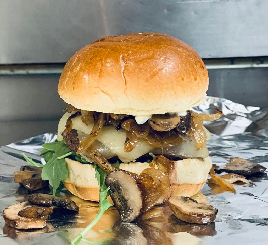 French Onion Mushroom · Your choice of house smoked chicken or seasoned 1/3 LB burger topped with gouda cheese, sauteed mushrooms & onions sauteed in a red wine stock over mixed greens and garlic herb aioli on a potato roll.