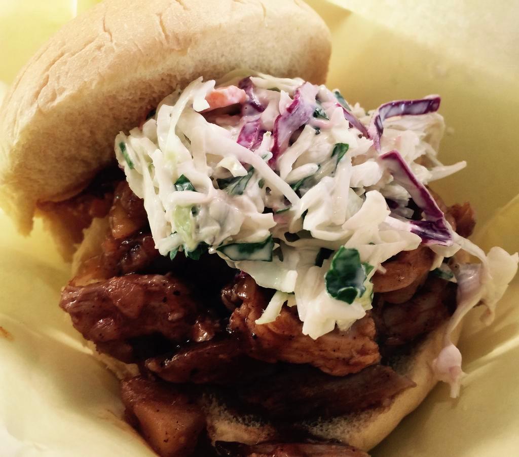 Mason Dixon Pulled Pork · House smoked pulled pork with sauteed granny smith apples & vidalia onions in a sweet & tangy BBQ sauce topped with cilantro cole slaw on a potato roll. 