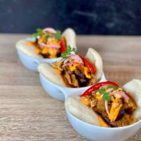 Gua Bao · Braised seitan, fennel, star anise, ginger, agave, smoked pepper sauce, Thai chili, crushed ...