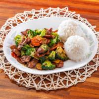 Broccoli Beef · Beef sautéed with broccoli, water chestnuts, bamboo shoots, and carrots, served with rice.