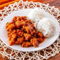 General Tao's Chicken · Deep fried chicken sautéed with peas and carrots in a mildly spicy sauce, served with rice.