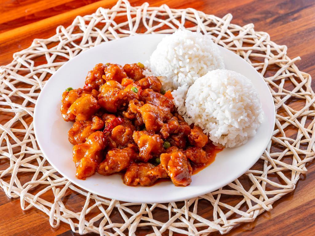 General Tao's Chicken · Deep fried chicken sautéed with peas and carrots in a mildly spicy sauce, served with rice.