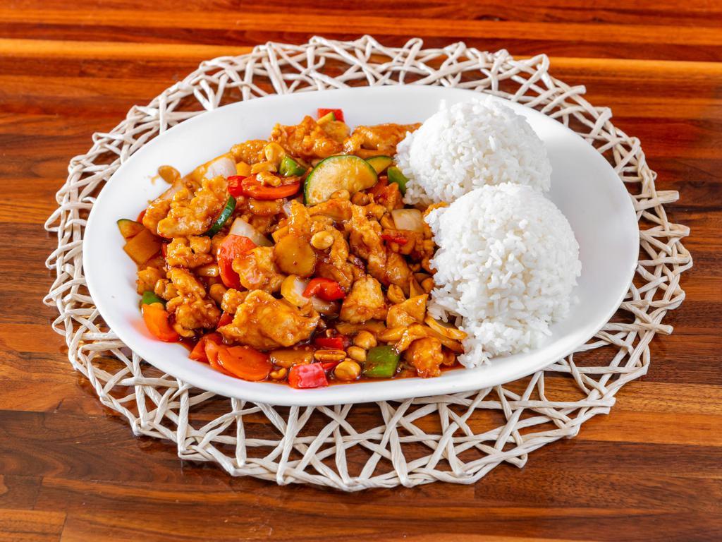 Kung Pao Chicken · Chicken sautéed with peas, carrots, zucchini, onion, water chestnuts, and bamboo shoots in a spicy sauce, served with rice.