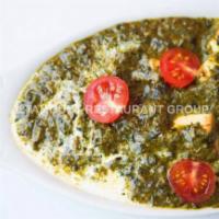 Palak Paneer. · Simmered Spinach with spices and Paneer cubes.