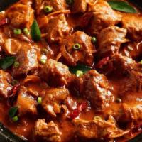 Goat Rogan Josh. · Goat with bone cooked in tomato gravy and spices.