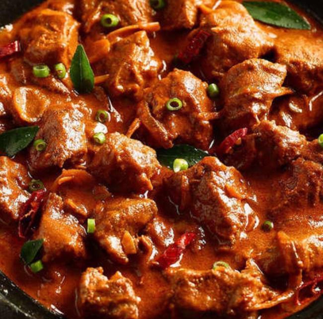 Goat Rogan Josh. · Goat with bone cooked in tomato gravy and spices.