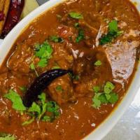 Goat Curry. · Goat with bone cooked in South Indian spices.