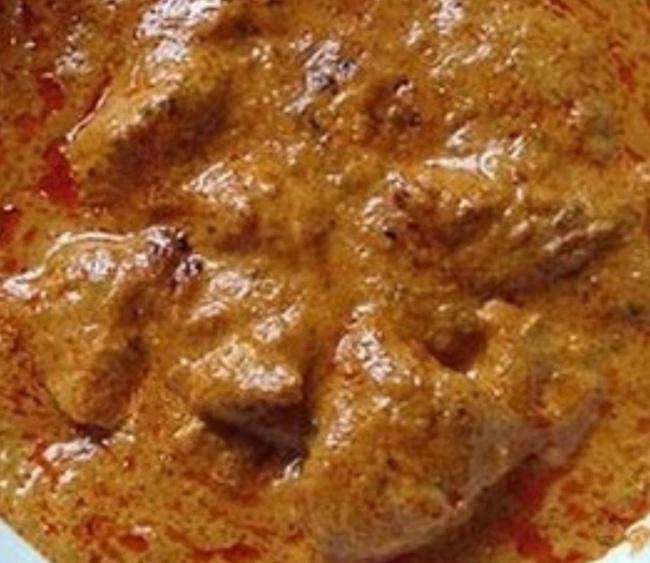 Goat Korma. · Goat with bone cooked in cashews and spices.
