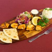 Chicken Skewered Kebab · Grilled skewers of marinated chicken tenders. Served with the rice, salad, pita and sauce.