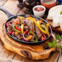 Steak Fajitas · Tender slices of steak cooked with onions, tomatoes, and peppers. 