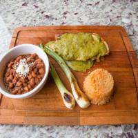 Pollito Ahogado · Prosciutto and Chihuahua stuffed grilled chicken breast in creamy poblano salsa, calabasita ...