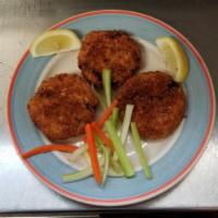 Louisiana Crab Cakes · Lump crabmeat and the essentials. Served with tartar sauce.