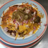 TCD Famous Chili · Hearty beef and black beans in a mildly spiced sauce, served over rice with chopped onions a...