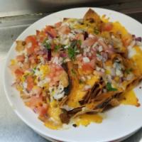 Mucho Nachos · Corn tortilla chips topped with beef chilli, shredded jack cheese, diced tomatoes, onions, s...