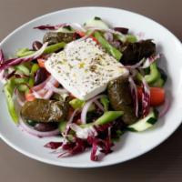 Greek Salad · Romaine lettuce, tomatoes, cucumbers, feta, black olives, anchovies, dolmadakia and garnish....