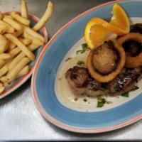 NY Sirloin Steak · 16+ oz. cut choice NY sirloin char grilled and served with sauteed mushrooms. Served with po...