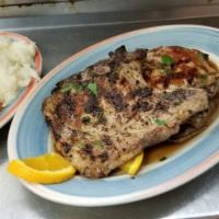 Pork Chops · Butcher cut pork chops broiled, with caramelized apples and onions. Served with potato, vegg...