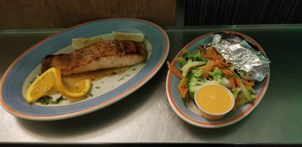 Grilled Norwegian Salmon · Fresh salmon grilled to perfection. Served with potato, vegetable, and cup of soup or mixed green salad. 